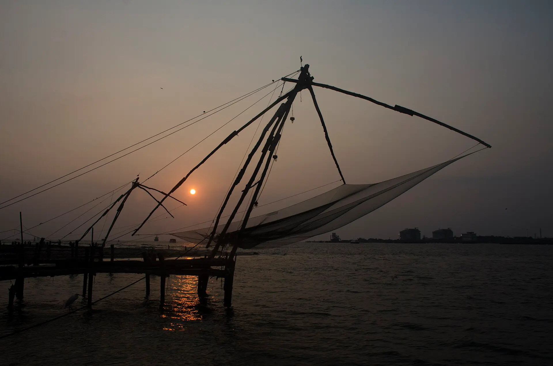 Chinese fishing nets on the waterfront at sunset in Fort Kochi